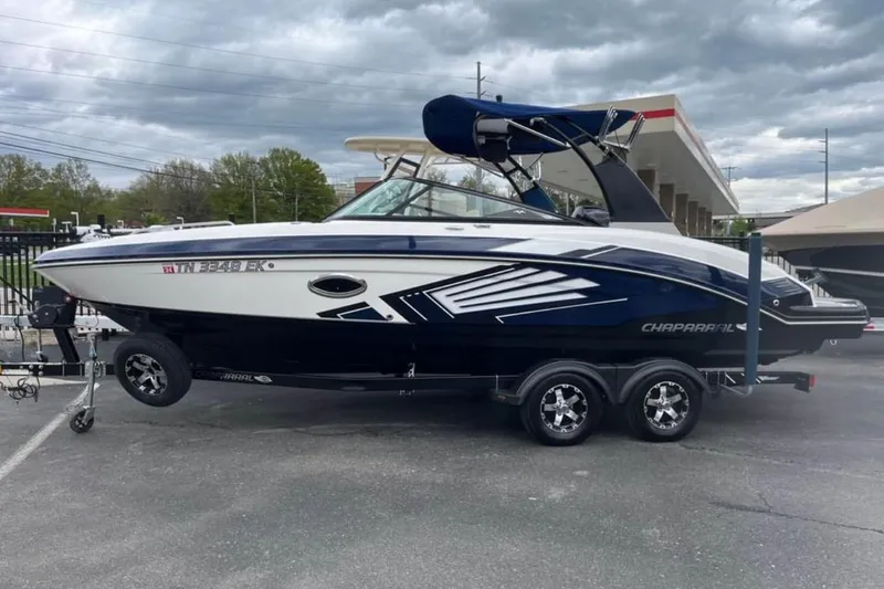 Slide: The Image of 2016 Chaparral Vortex 243 VRX boat on trailer, parked outdoors under cloudy sky. - 6