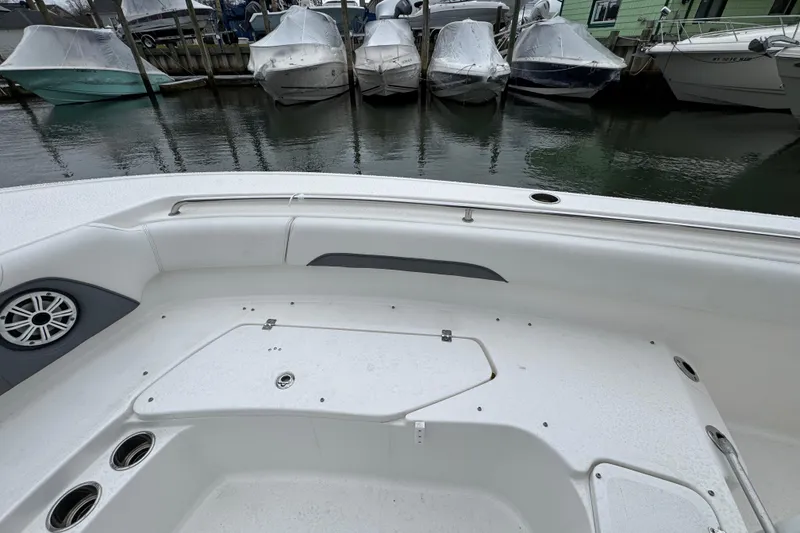 Slide: The Image of 2018 Tidewater 252 LXF boat interior with docked boats in background. - 13