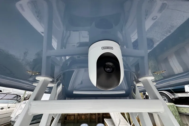 Slide: The Image of 2018 Tidewater 252 LXF boat with mounted camera under blue canopy. - 19