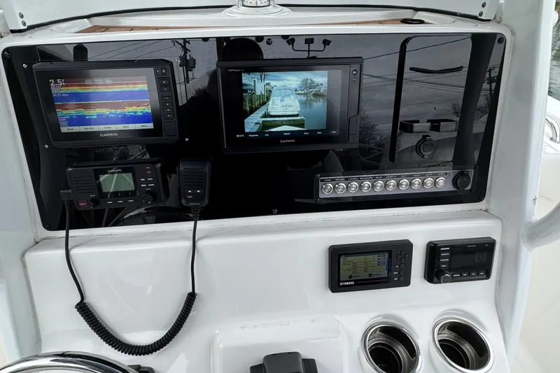 Slide: The Image of 2018 Tidewater 252 LXF boat dashboard with Garmin navigation and control systems. - 21