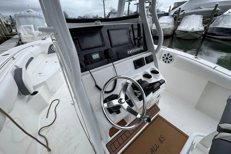 Slide: The Image of 2018 Tidewater 252 LXF boat cockpit with steering wheel and navigation equipment. - 7