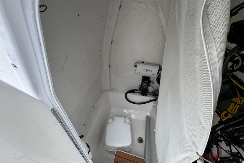 Slide: The Image of Interior view of a 2018 Tidewater 252 LXF boat's compact bathroom area. - 8