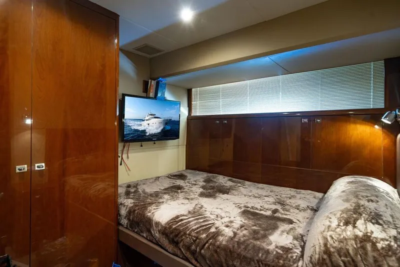 Slide: The Image of Luxurious bedroom interior on 2010 Princess 95 Motor Yacht with TV and plush bedding. - 110
