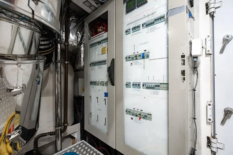 Slide: The Image of Engine room of 2010 Princess 95 Motor Yacht with control panels and piping. - 119