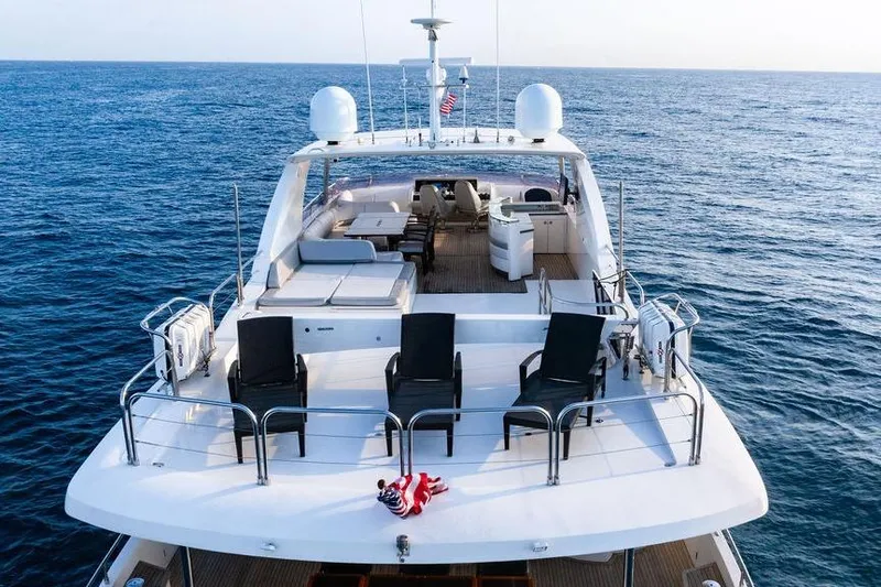 Slide: The Image of Luxurious 2010 Princess 95 Motor Yacht cruising on open sea, featuring spacious deck. - 124