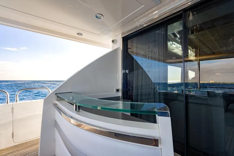 Slide: The Image of Luxurious 2010 Princess 95 Motor Yacht with sleek glass railing and ocean view. - 23