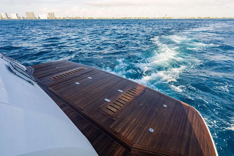 Slide: The Image of Princess 95 Motor Yacht 2010 cruising on blue ocean waters, wooden deck view. - 25