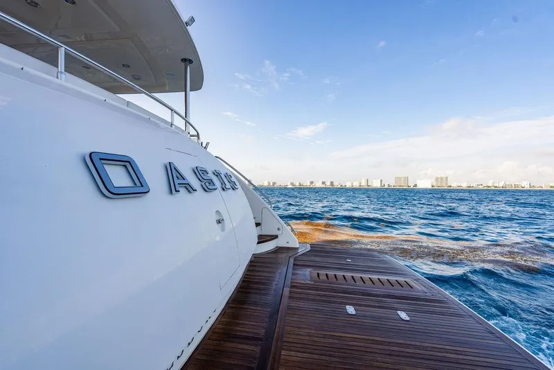 Slide: The Image of 2010 Princess 95 Motor Yacht on open sea with city skyline in background. - 26
