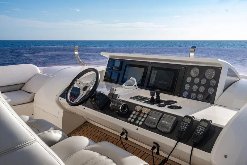 Slide: The Image of Helm of 2010 Princess 95 Motor Yacht with ocean view, featuring advanced navigation controls. - 56
