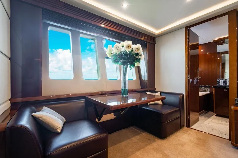 Slide: The Image of Luxurious interior of 2010 Princess 95 Motor Yacht with elegant seating and floral centerpiece. - 94