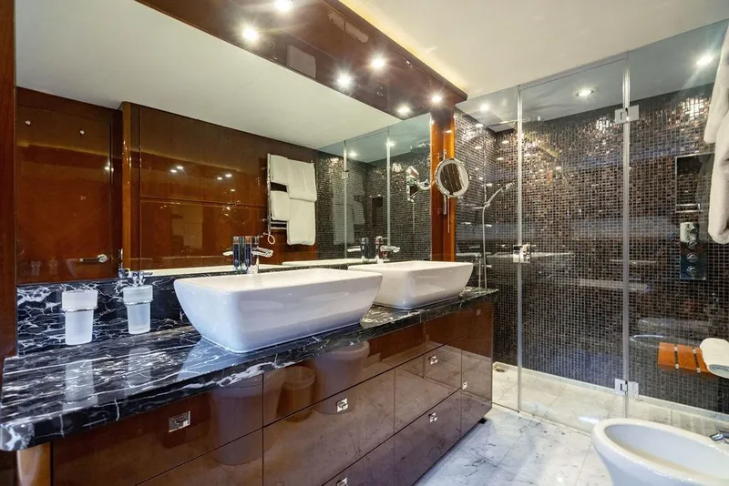 Slide: The Image of Luxurious bathroom on 2010 Princess 95 Motor Yacht with dual sinks and glass shower. - 95