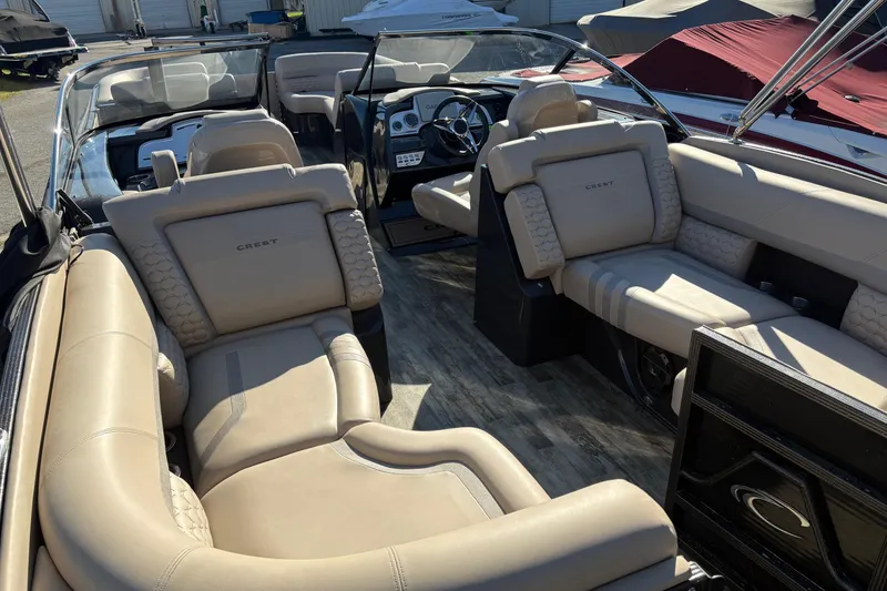 Slide: The Image of Luxurious interior of 2022 Crest Continental 250 boat with beige seating and modern dashboard. - 10