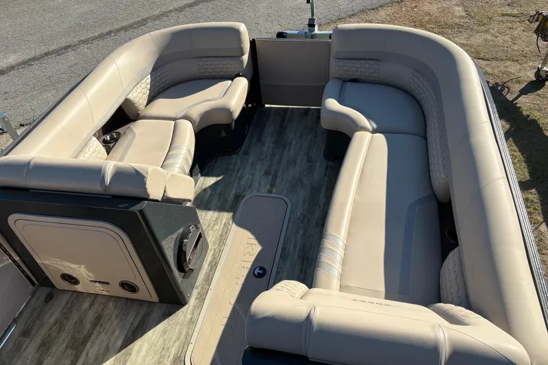 Slide: The Image of Luxurious seating on 2022 Crest Continental 250 pontoon boat, featuring beige upholstery and spacious layout. - 4