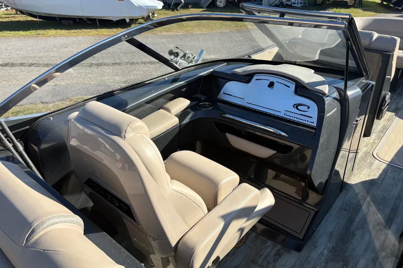 Slide: The Image of Interior of a 2022 Crest Continental 250 boat with beige seating and sleek dashboard design. - 8