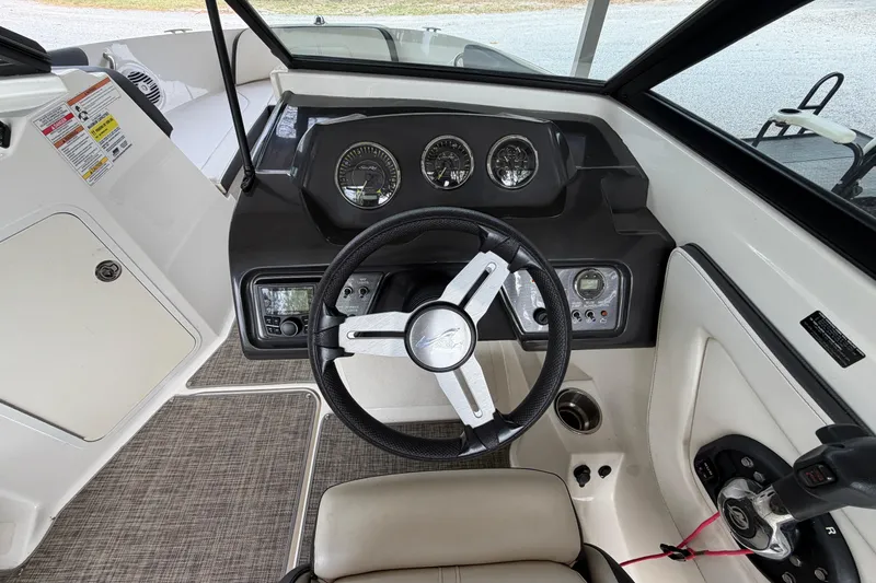 Slide: The Image of 2017 Sea Ray SPX 190 boat dashboard with steering wheel and control panel. - 11