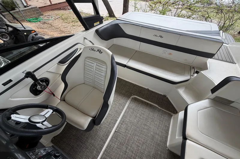 Slide: The Image of 2017 Sea Ray SPX 190 boat interior with steering wheel and seating area. - 12
