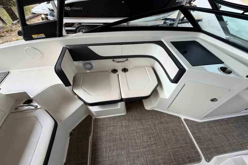 Slide: The Image of Interior of a 2017 Sea Ray SPX 190 boat, featuring cushioned seating and storage compartments. - 13