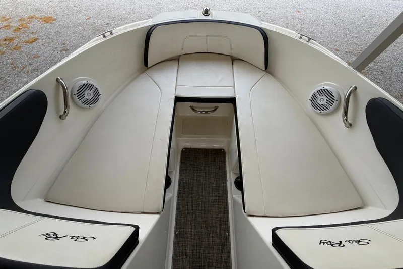 Slide: The Image of 2017 Sea Ray SPX 190 boat interior with white seating and speakers. - 15