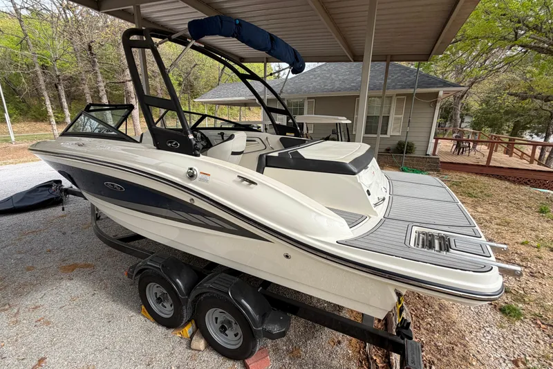 Slide: The Image of 2017 Sea Ray SPX 190 boat on trailer under shelter, parked near a house. - 3