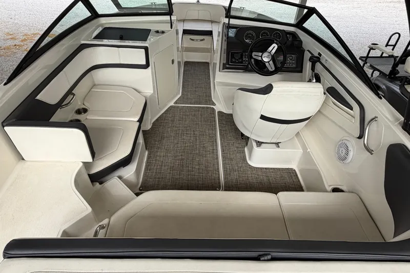Slide: The Image of 2017 Sea Ray SPX 190 boat interior with seating, steering wheel, and dashboard. - 8