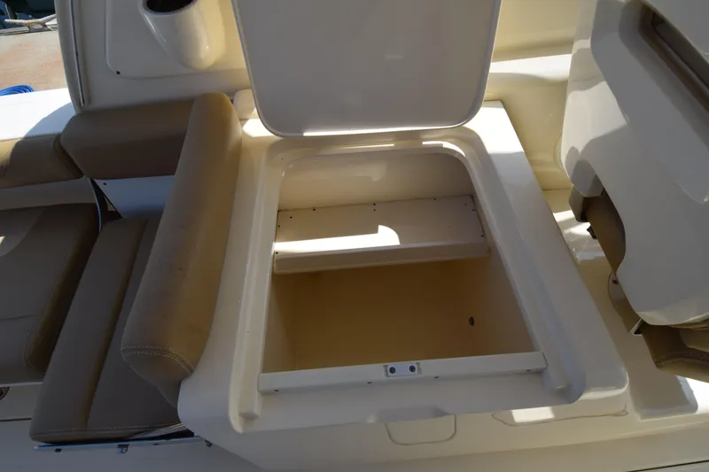 Slide: The Image of Open storage compartment on a 2017 Scout 275 Dorado boat, featuring beige seating. - 21