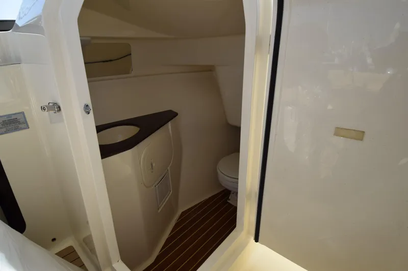 Slide: The Image of Interior view of 2017 Scout 275 Dorado boat bathroom with sink and toilet. - 23