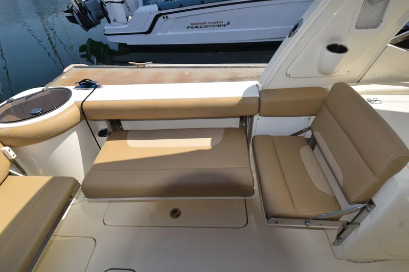 Slide: The Image of 2017 Scout 275 Dorado boat interior with tan seating and fishing rod holder. - 5