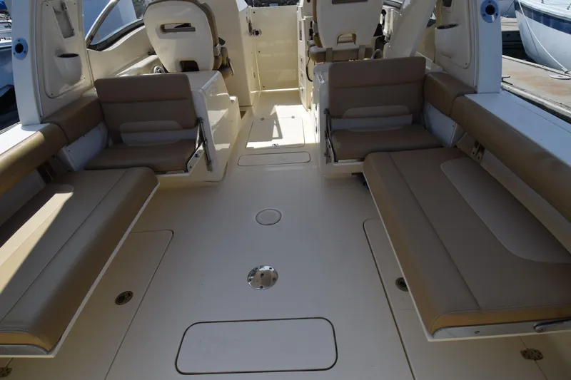Slide: The Image of 2017 Scout 275 Dorado boat interior with beige seating and spacious layout. - 6
