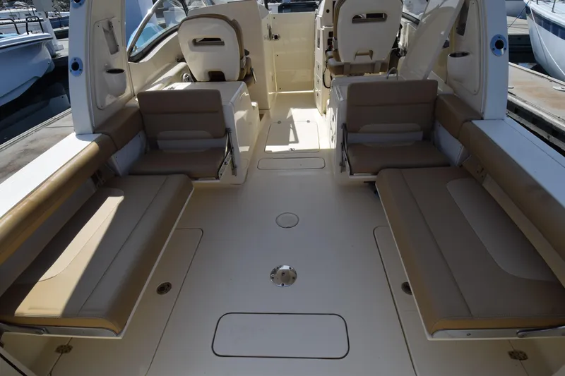 Slide: The Image of 2017 Scout 275 Dorado boat interior with beige seating and spacious layout. - 8