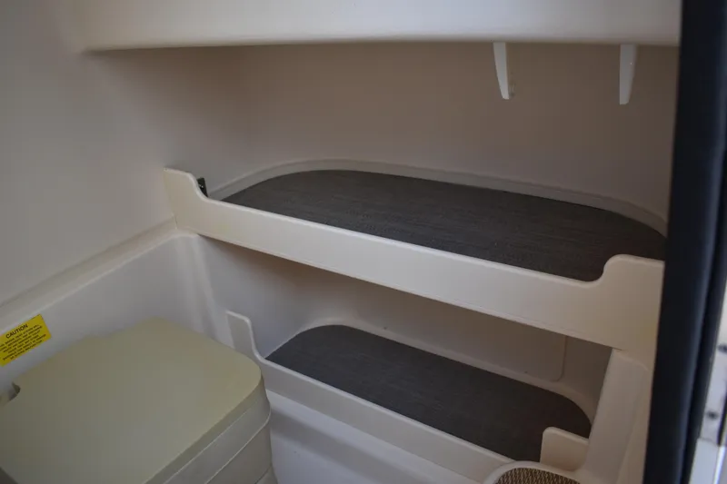 Slide: The Image of 2017 Grady-White Fisherman 257 boat lifted in marina, clear blue sky background. - 2