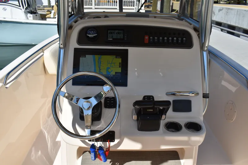 Slide: The Image of 2017 Grady-White Fisherman 257 boat dashboard with steering wheel and navigation display. - 20