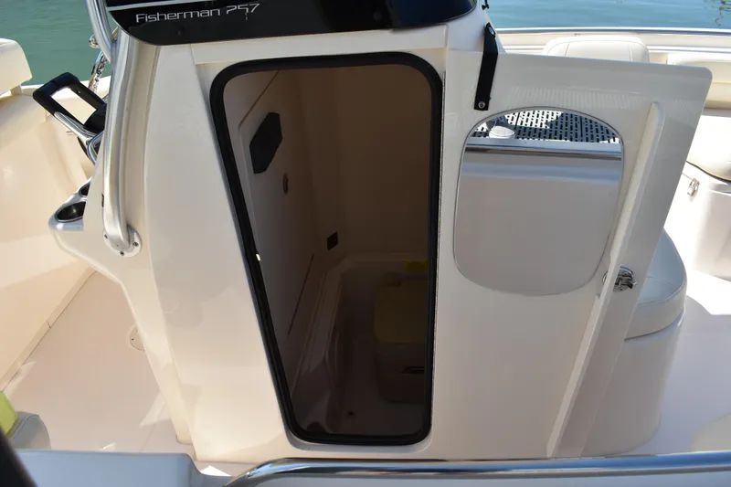 Slide: The Image of 2017 Grady-White Fisherman 257 boat docked, covered seats, calm marina setting. - 5