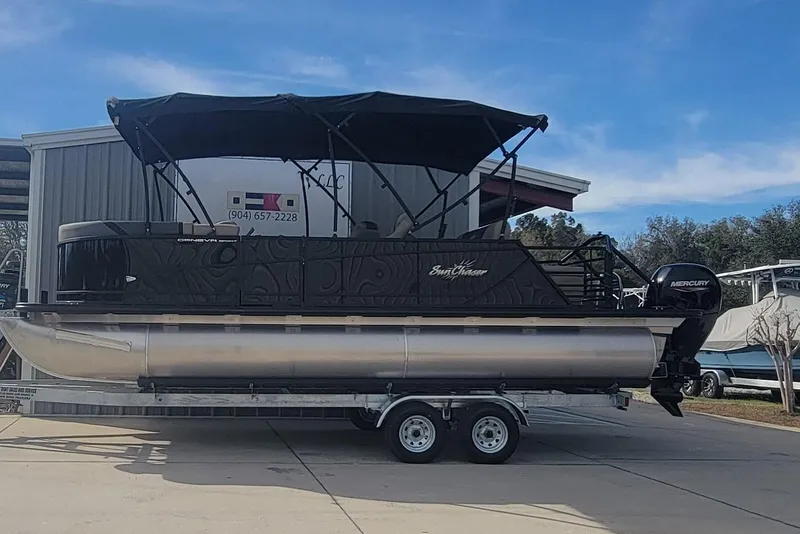 The Image of 2026 SunChaser Geneva Cruise 24 LR DH Sport pontoon boat on trailer, outdoor setting. - 1