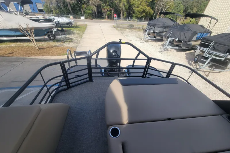 Slide: The Image of 2026 SunChaser Geneva Cruise 24 LR DH Sport pontoon boat, rear view with seating and motor. - 3