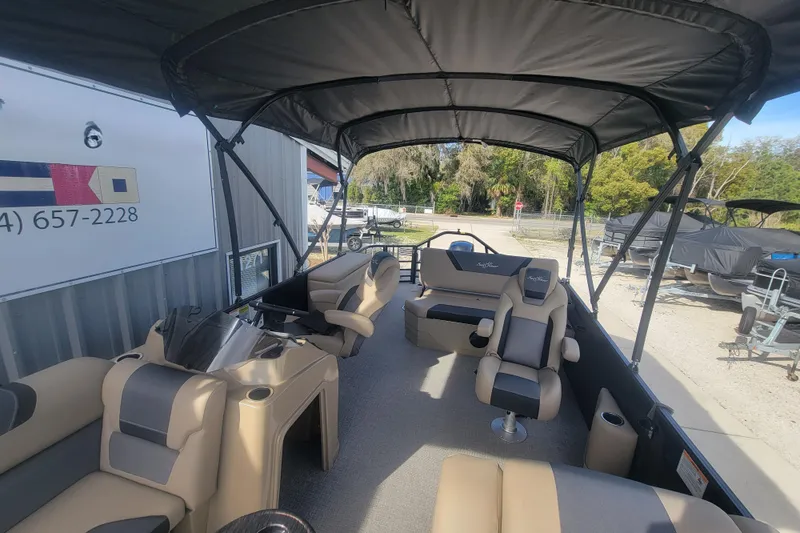 Slide: The Image of 2026 SunChaser Geneva Cruise 24 LR DH Sport pontoon boat interior with seating and canopy. - 4