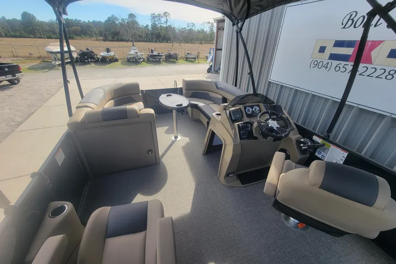 Slide: The Image of Interior of 2026 SunChaser Geneva Cruise 24 LR DH Sport pontoon boat, featuring seating and helm. - 5