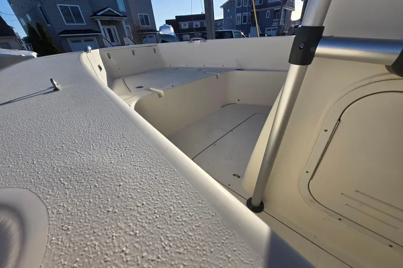 Slide: The Image of 2015 Scout 195 Sportfish boat interior, showcasing seating and storage compartments. - 13