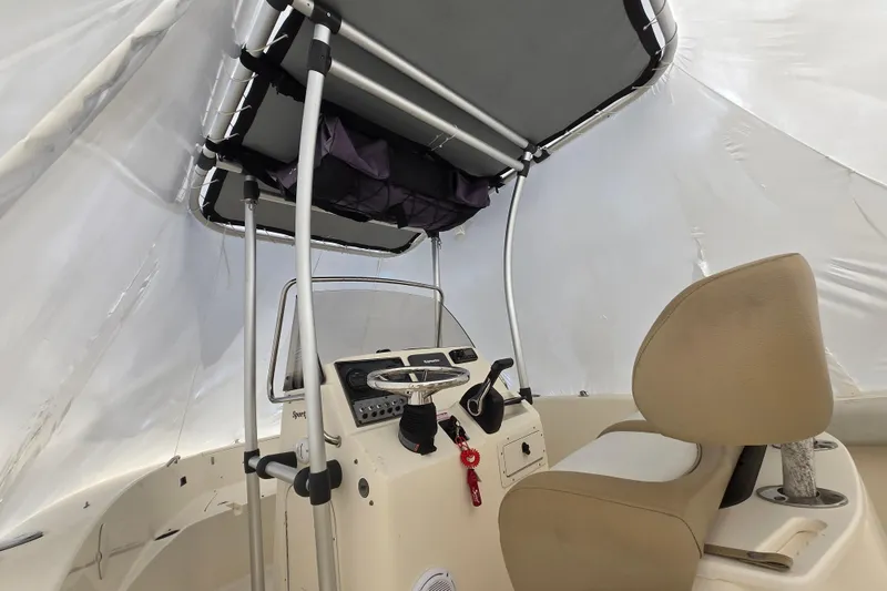 Slide: The Image of Interior view of 2015 Scout 195 Sportfish boat with steering console and seating. - 14
