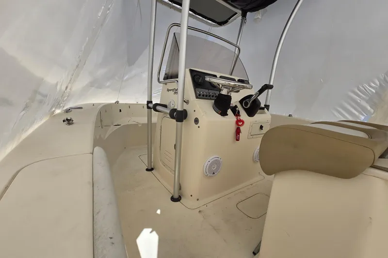 Slide: The Image of 2015 Scout 195 Sportfish boat interior with steering console and seating. - 17