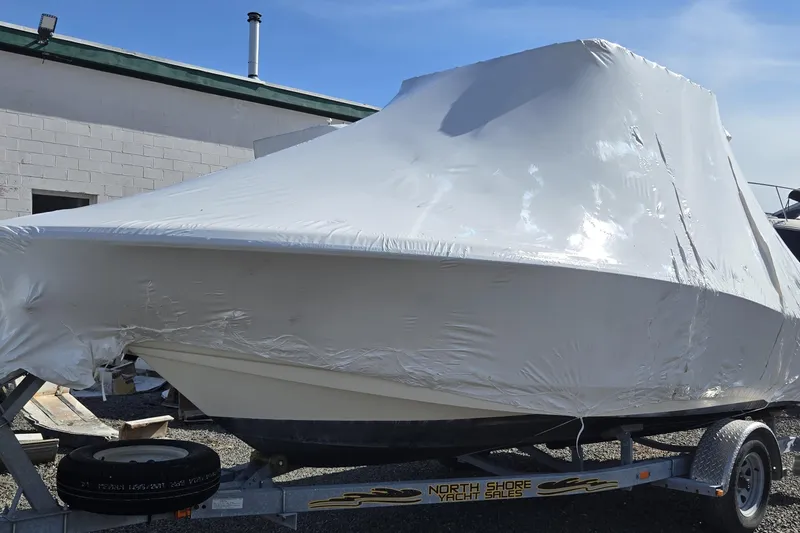 Slide: The Image of 2015 Scout 195 Sportfish boat interior with seating and console, showcasing sleek design. - 7