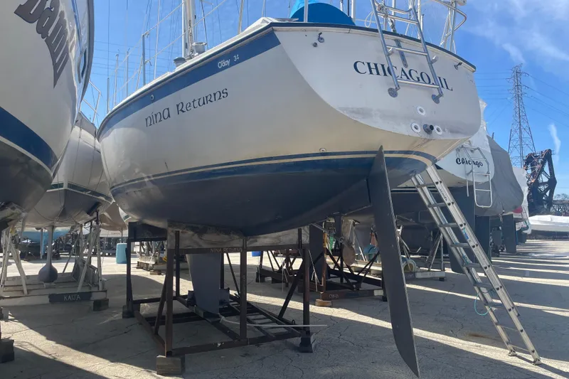 The Image of 1982 O'Day 34 sailboat docked at marina during sunset. - 0