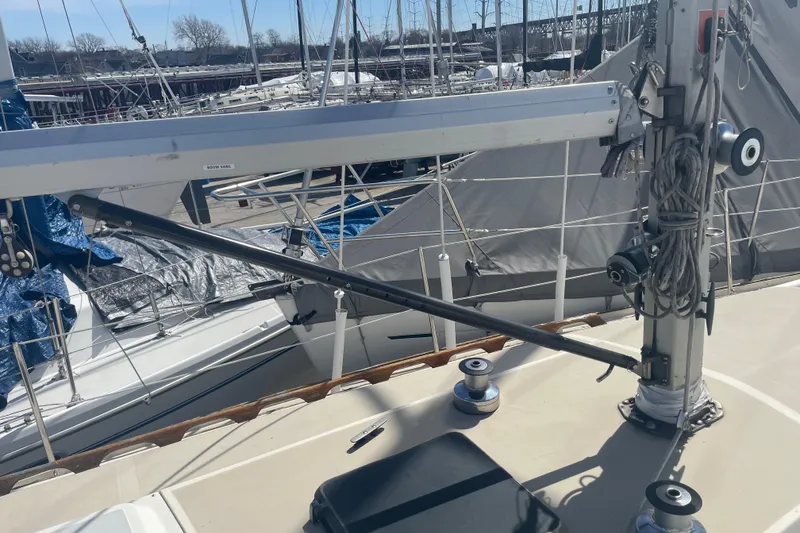 Slide: The Image of 1982 O'Day 34 sailboat deck with blue cover, docked among other boats. - 13