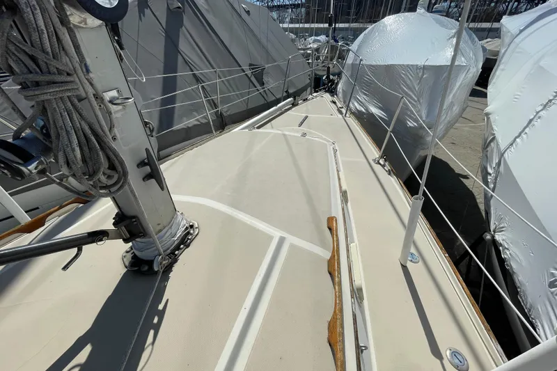 Slide: The Image of 1982 O'Day 34 sailboat deck with rigging and winches in a marina. - 14