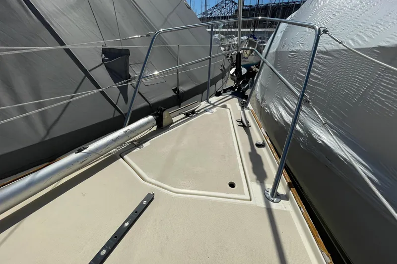 Slide: The Image of 1982 O'Day 34 sailboat deck with rigging and winches in a marina. - 15