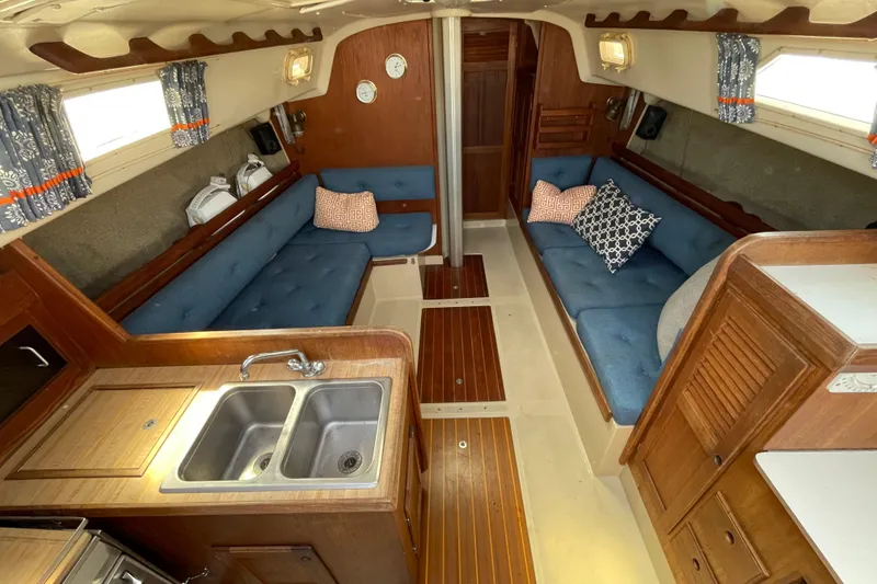 Slide: The Image of 1982 O'Day 34 sailboat deck with railings and covered surroundings. - 17