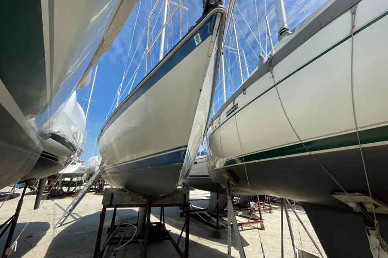 Slide: The Image of 1982 O'Day 34 sailboat on stands, with ladder and clear sky background. - 2