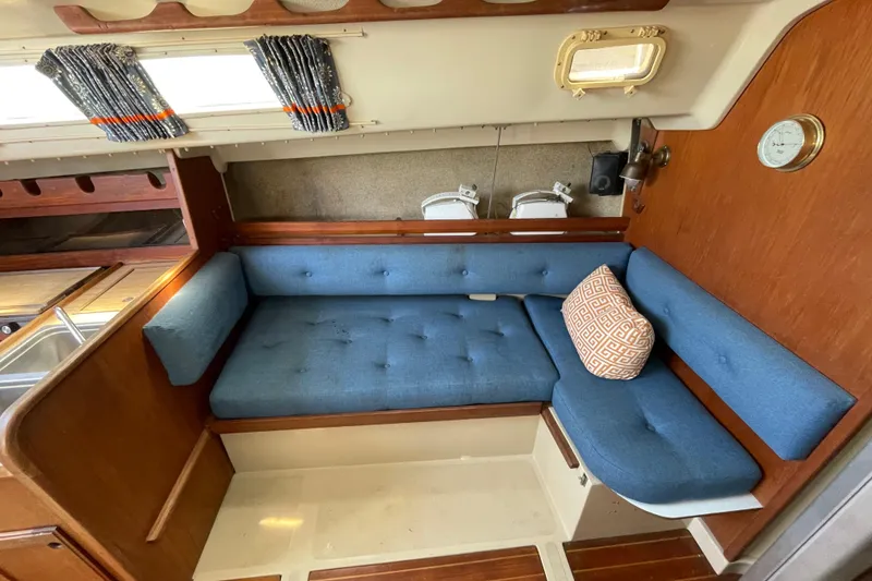 Slide: The Image of Interior cabin of a 1982 O'Day 34 sailboat with blue cushioned berth. - 23