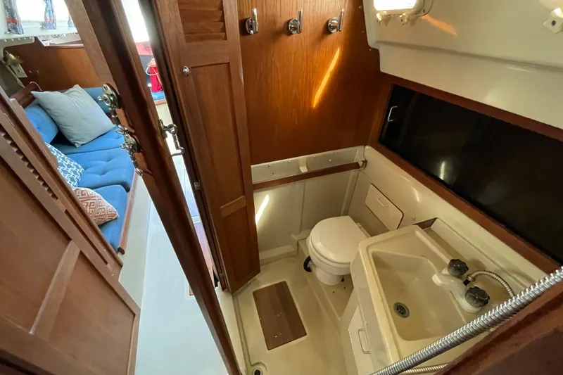 Slide: The Image of Interior cabin of a 1982 O'Day 34 sailboat with cozy V-berth and natural lighting. - 28
