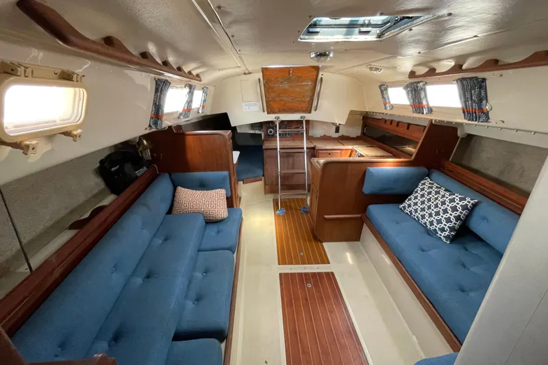 Slide: The Image of Interior of a 1982 O'Day 34 sailboat featuring a compact bathroom and cozy cabin area. - 29