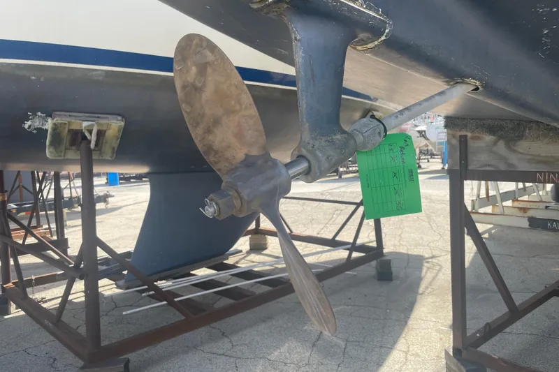 Slide: The Image of 1982 O'Day 34 sailboat on stands, surrounded by other boats under a clear blue sky. - 5